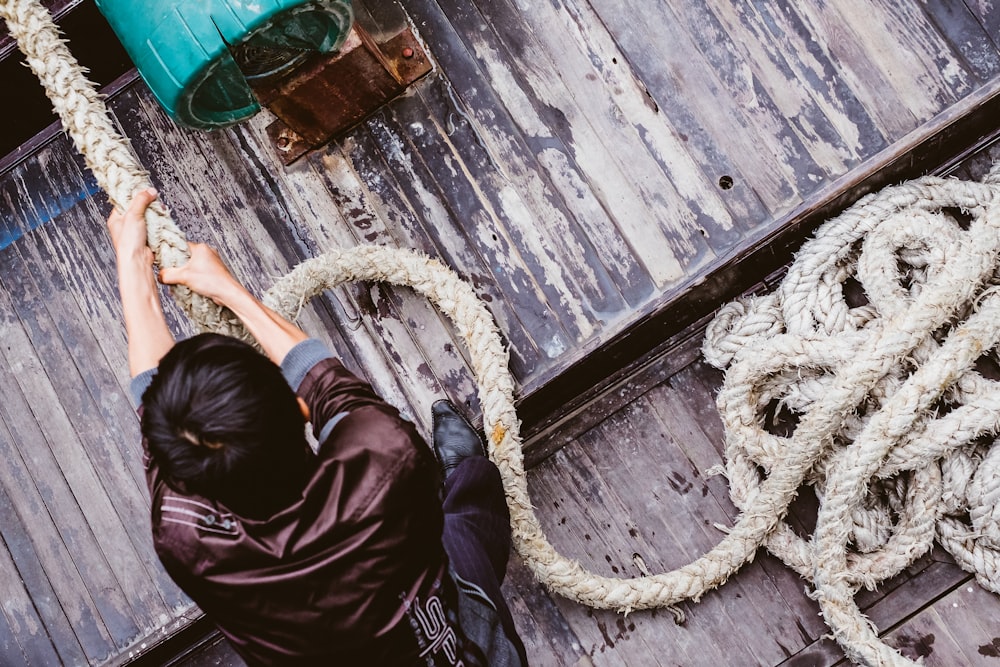 man pulling gray rope