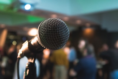 silver corded microphone in shallow focus photography kings teams background