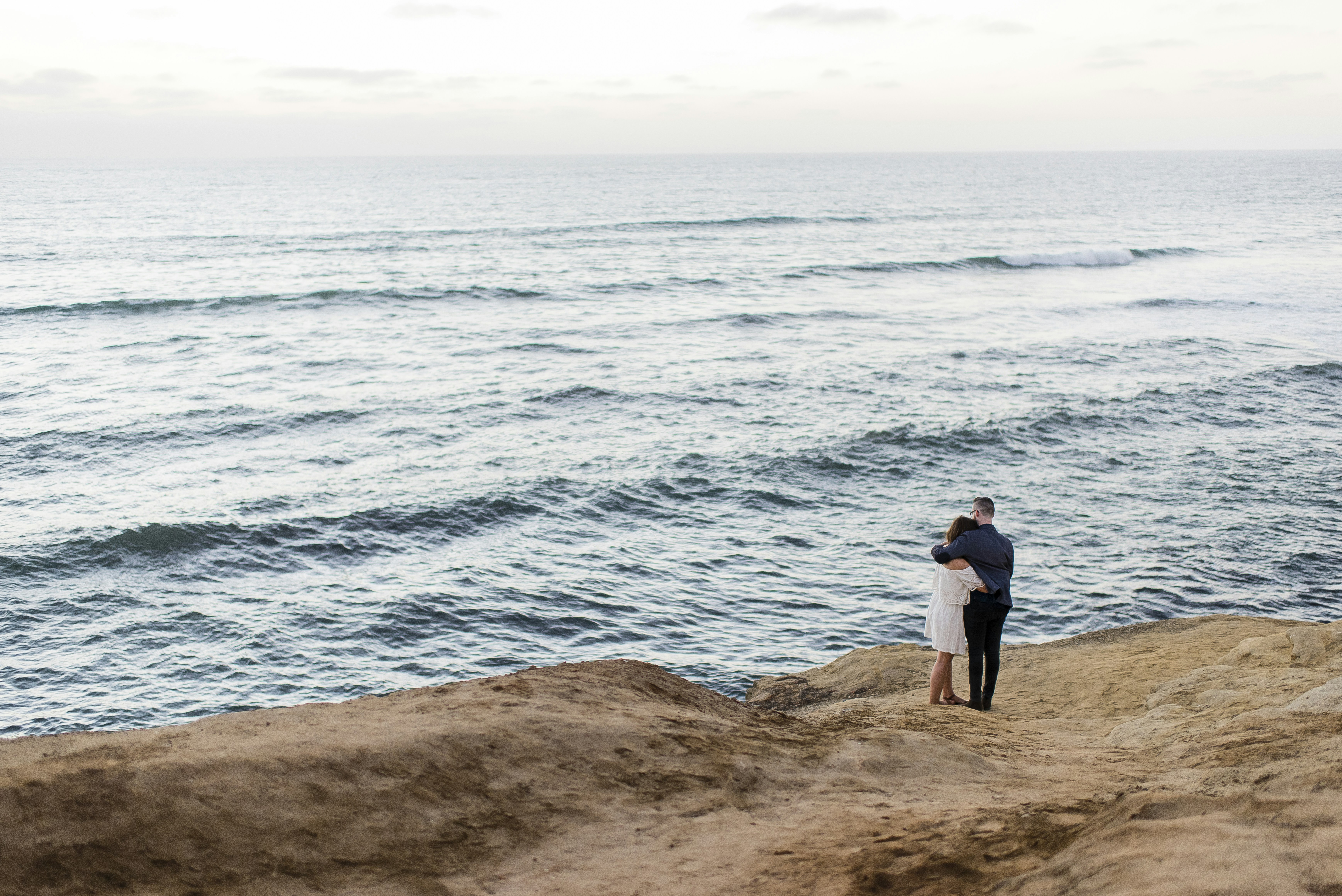 Couple embrace Sunset Cliffs