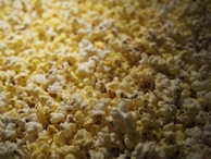 Close-up of freshly popped popcorn spilling from a vintage popcorn machine