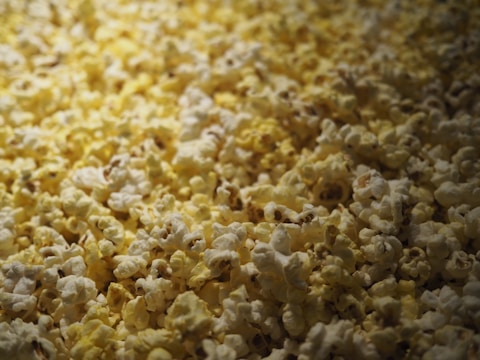 A close-up of popcorn and cozy blankets ready for movie night.