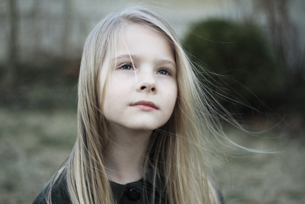 close-up photography of girl in black top during daytime