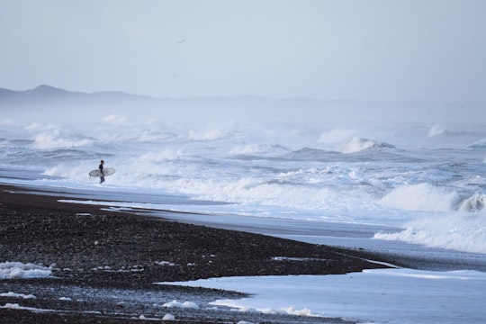 surfboard about to meet wild waves in Klitmøller Denmark