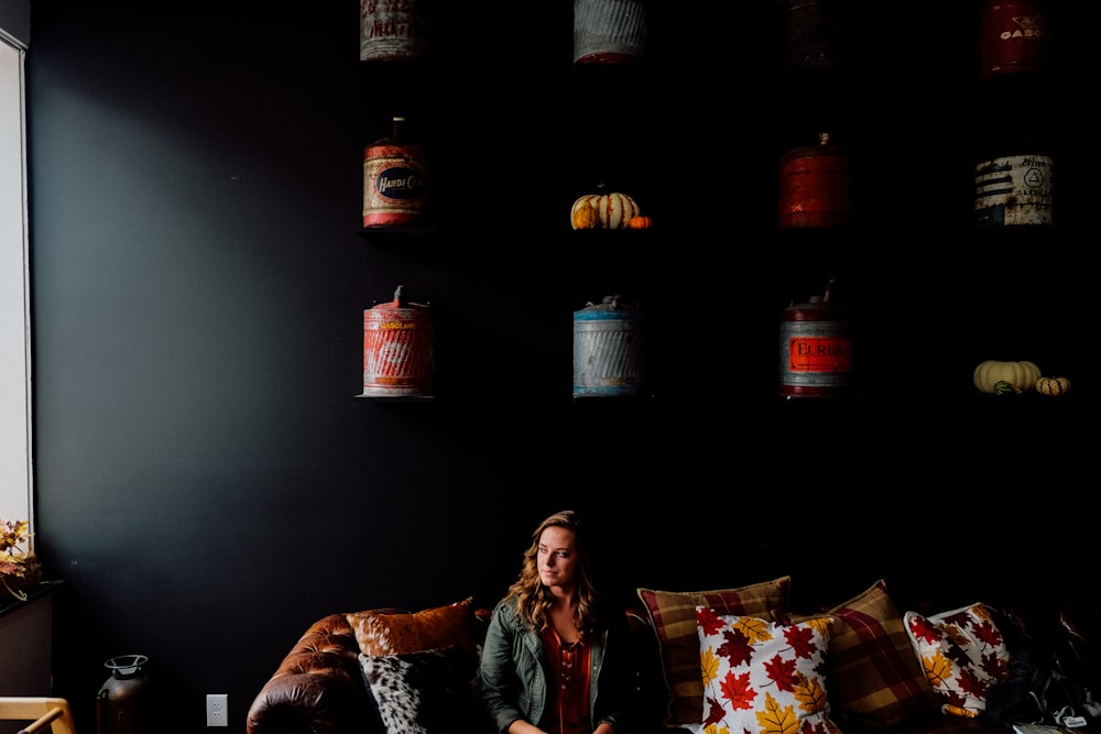 woman sitting on couch with throw pillows inside the room