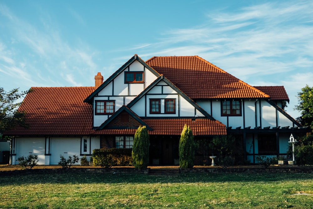 A large suburban house with a garden on a sunny day