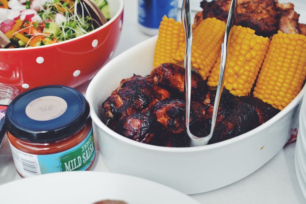 grilled food and corn cob on oval pan