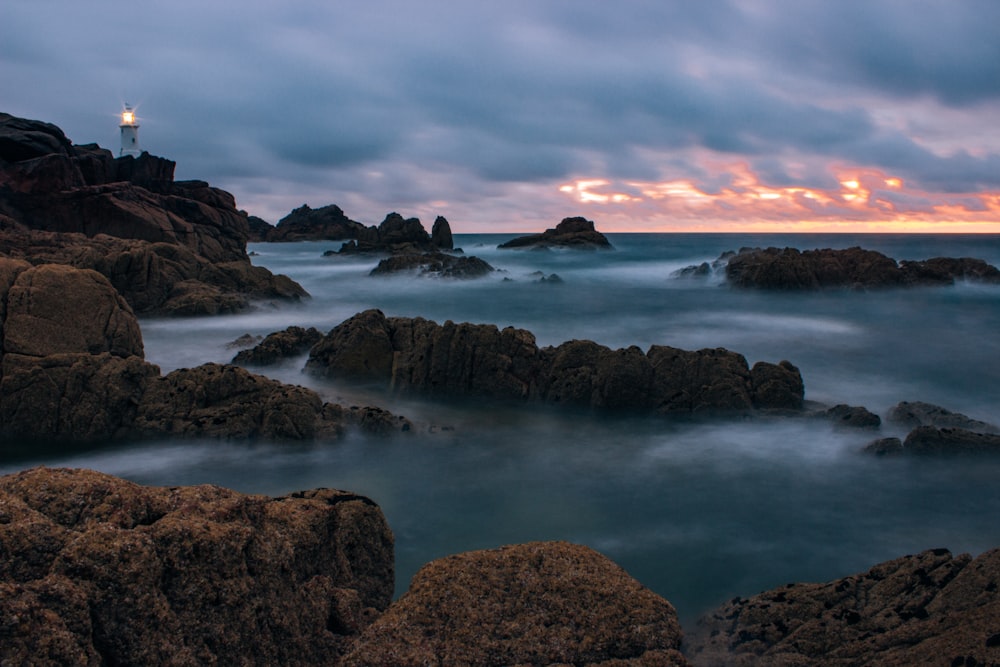 rock formation under cloudy sky