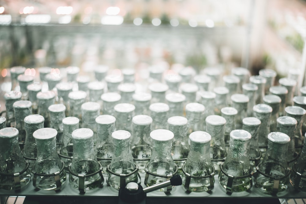 a bunch of empty glass jars sitting on top of a table