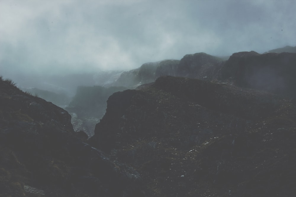 fotografia de paisagem de montanhas cobertas de nevoeiro