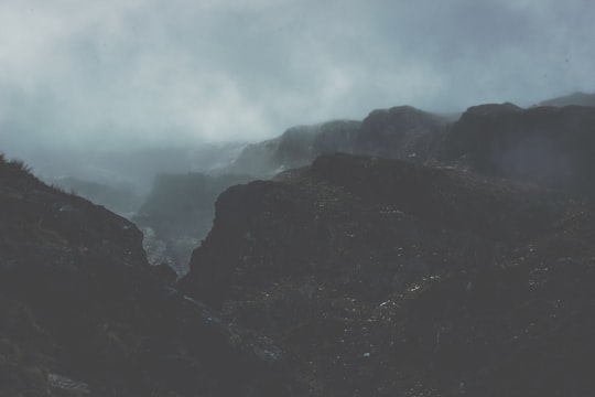 landscape photography of mountains covered in fog in Mount Aspiring National Park New Zealand