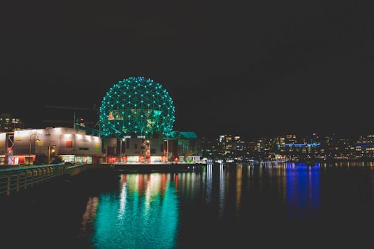 blue and white ball on body of water during night time in Science World at TELUS World of Science Canada