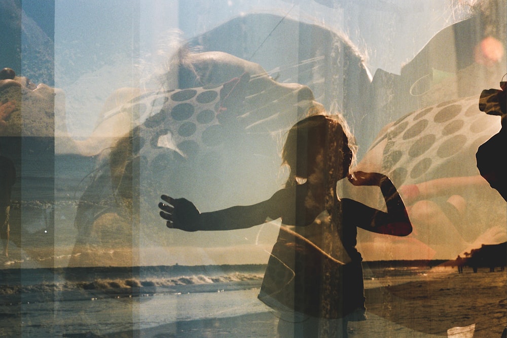 a woman standing in front of a window next to a giraffe