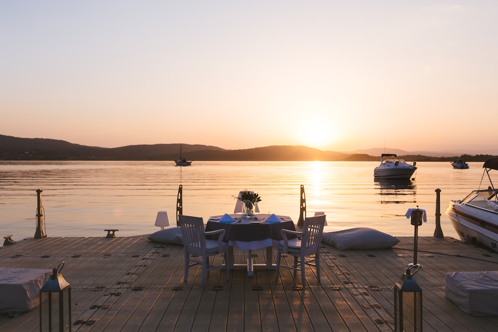 a dock with a table and chairs on it