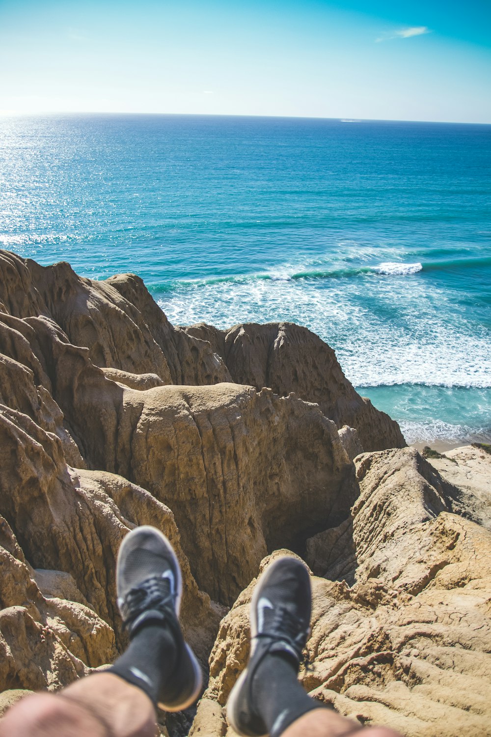 person sitting on cliff