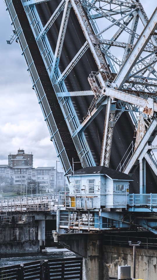 black, white, and black bascule bridge under white skies in Victoria Canada