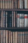assorted books in brown wooden bookshelf