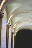 Architectural detail of smooth stone walls and rounded corners bathed in soft natural light.