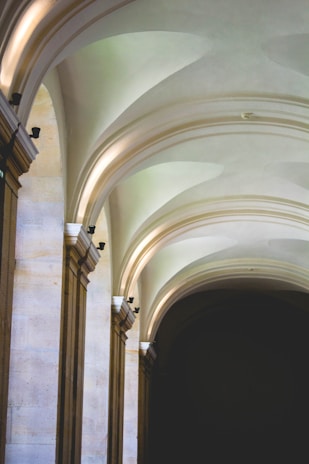 Elegant arches with soft natural lighting create a serene and timeless atmosphere. The stone structure features smooth, curved lines that enhance the architectural beauty of the space.