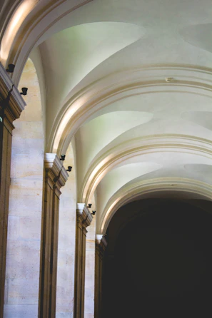 Architectural detail of smooth stone walls and rounded corners bathed in soft natural light.