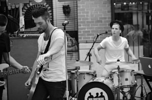 Behind-the-scenes candid of the band laughing and tuning instruments.