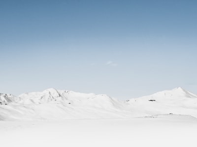 photography of snow covered mountain at daytime snow teams background