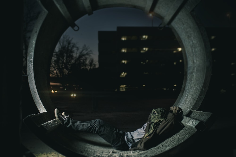 person laying inside hallway with building as background photo