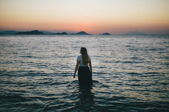 woman walking on body of water in Komodo National Park Indonesia