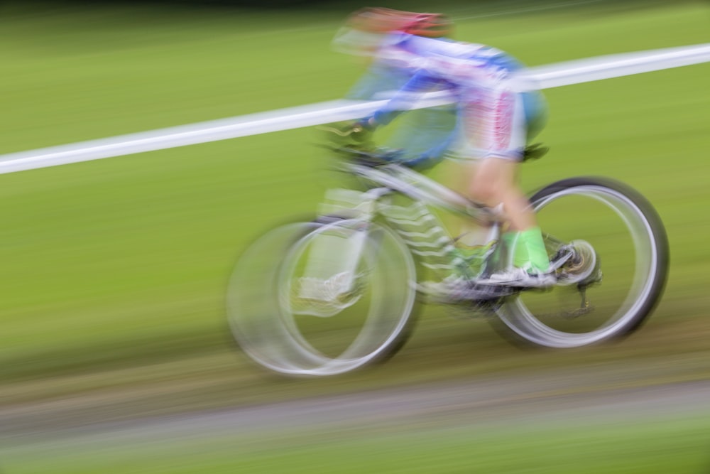 person biking on green field