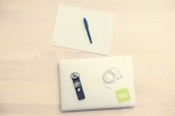 An organized workspace featuring laptops, audit checklists, and medical files.