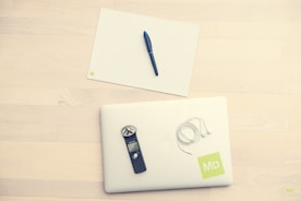 Audio recording device and legal notes ready for transcription.