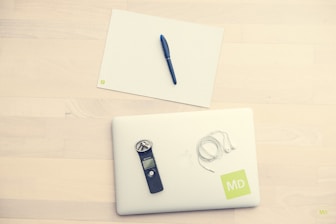 Audio recording device and legal notes ready for transcription.