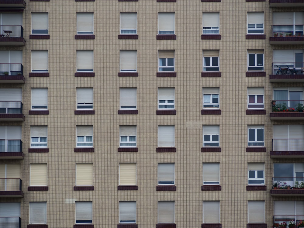 brown and red concrete building with windows