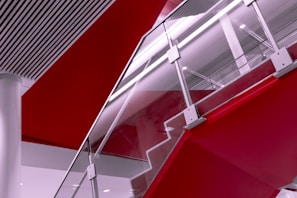 Contemporary steel and glass railing design in a staircase.