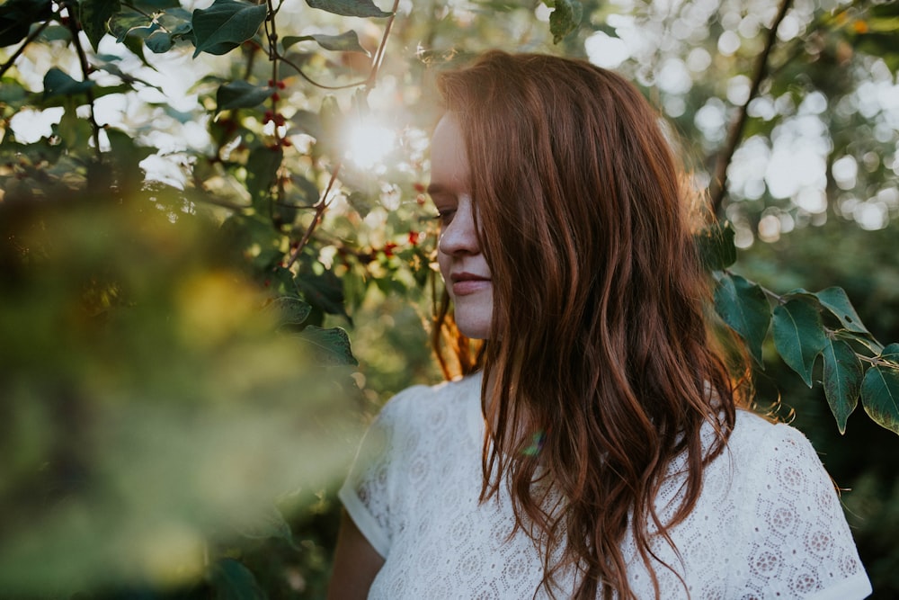 depth of field photography of woman wearing white lace top