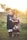 girl's left hand wrap around toddler while reading book during golden hour