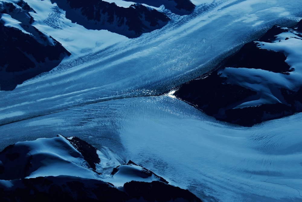 an aerial view of a snow covered mountain range