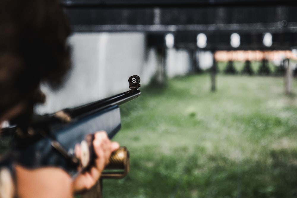 person aiming on the gun