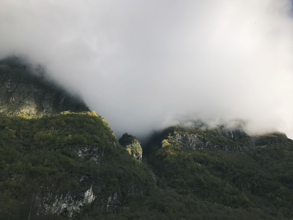 green mountain under cloudy sky