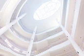 Community gathering in an open, airy space with natural light and minimalist design.