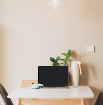 silver laptop computer on table