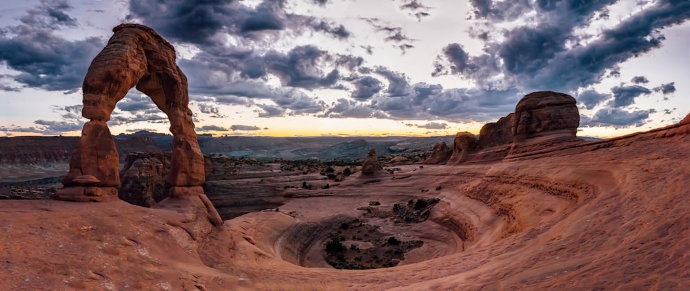 brown rock formation under white clouds and blue sky during daytime