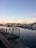 A serene marina scene with a clean, well-maintained boat docked at sunset.