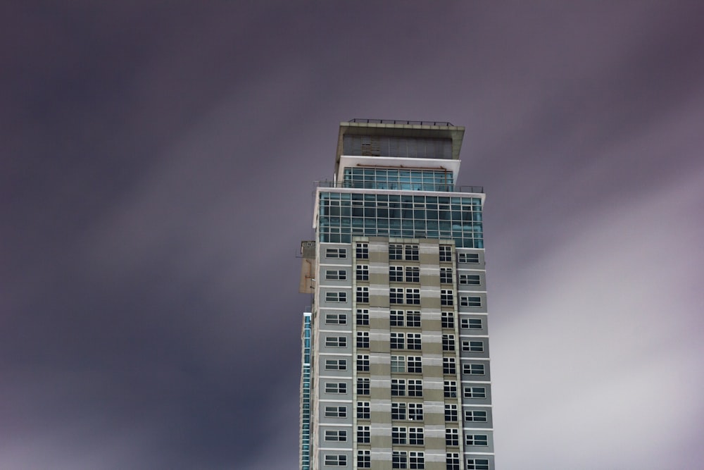 high rise building under cloudy sky