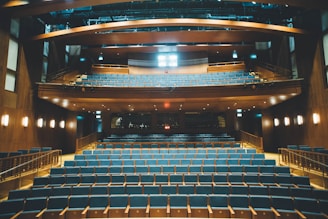 An empty auditorium ready for educational events with comfortable seating.