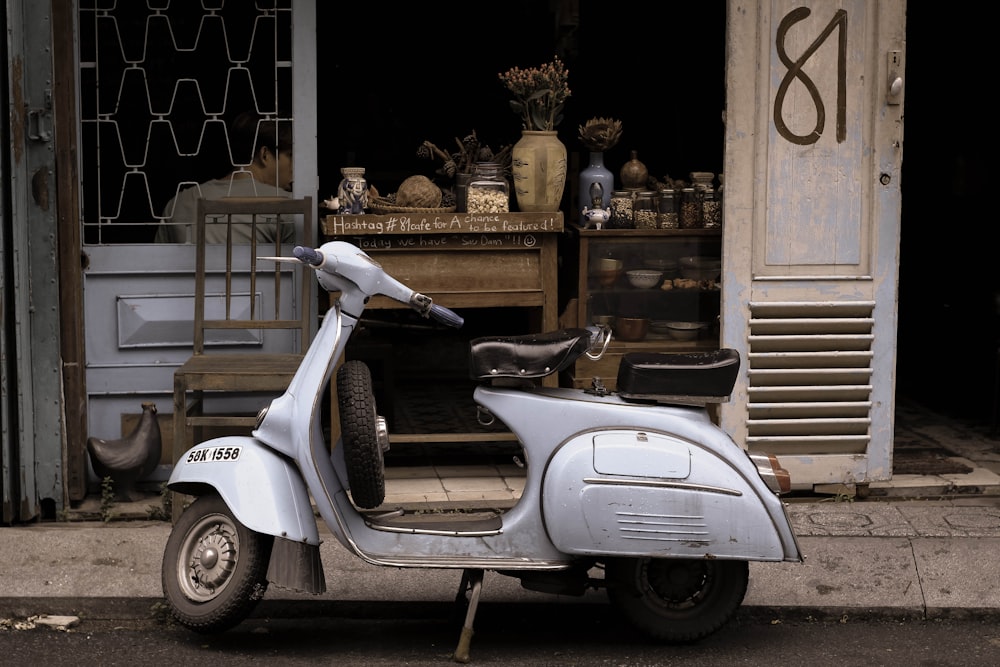 white motor scooter near store