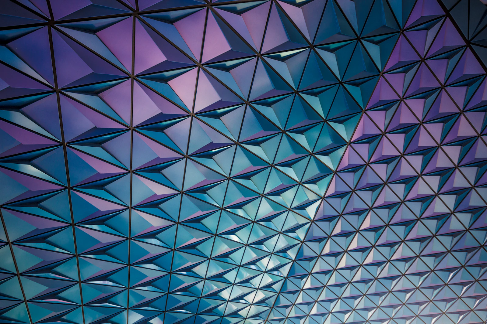 An abstract grid pattern in teal and pink, representing the structured, machine-readable format schema markup provides