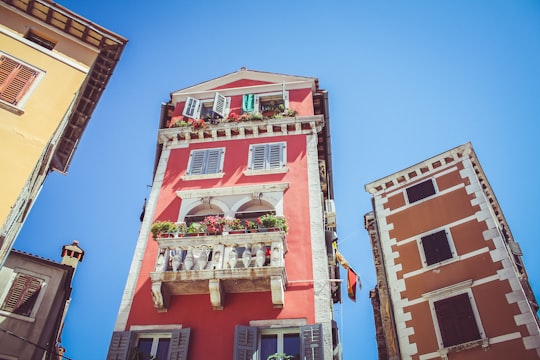 low angle photography of high-rise building under blue sky in Rovinj Croatia