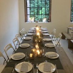 Modern dining space set for an intimate dinner with elegant tableware.