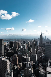 A sprawling vacant lot with city skyline in the background under a clear blue sky.