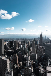 A sprawling vacant lot with city skyline in the background under a clear blue sky.